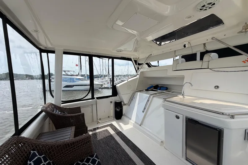 Slide: The Image of Interior of a 2002 Silverton 392 Motor Yacht with seating and kitchenette. - 8
