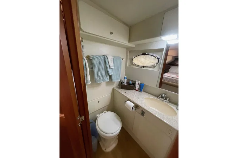 Slide: The Image of Bathroom interior of 2002 Silverton 392 Motor Yacht with sink, toilet, and towels. - 25