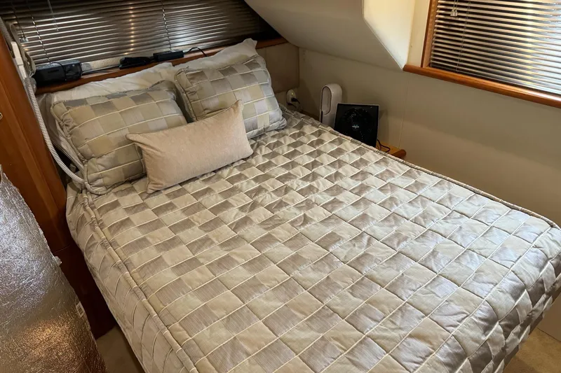 Slide: The Image of Cozy bedroom interior of 2002 Silverton 392 Motor Yacht with plaid bedding. - 47