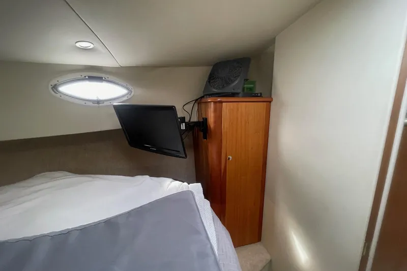Slide: The Image of 2002 Silverton 392 Motor Yacht cabin with TV, fan, and porthole window. - 36