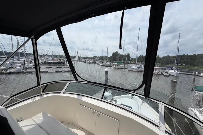 Slide: The Image of View from 2002 Silverton 392 Motor Yacht overlooking marina with sailboats and cloudy sky. - 11