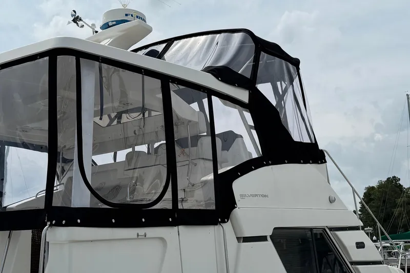 Slide: The Image of 2002 Silverton 392 Motor Yacht with enclosed flybridge, featuring sleek design and modern amenities. - 6
