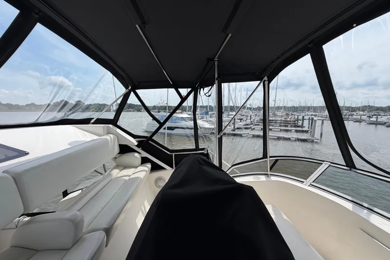 Slide: The Image of Interior view of 2002 Silverton 392 Motor Yacht with marina backdrop. - 12