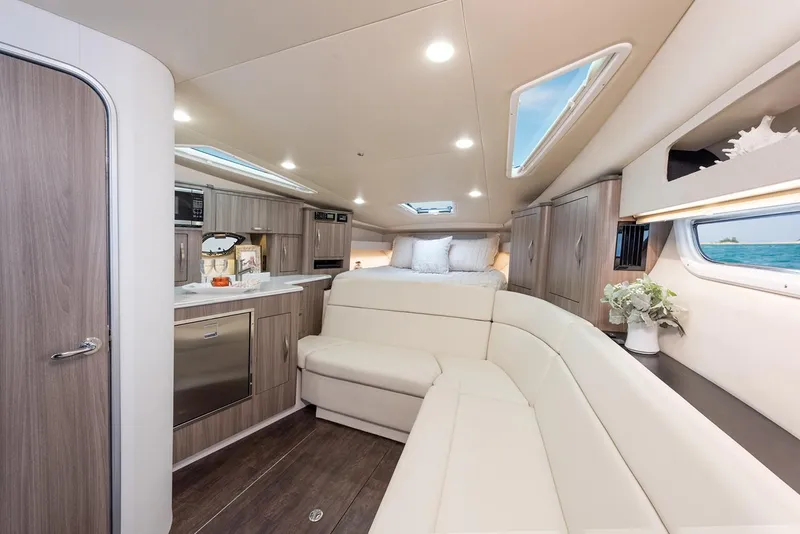 Slide: The Image of Manufacturer Provided Image: Luxurious interior of 2019 Regal 35 Sport Coupe with modern kitchen and cozy seating. - 11
