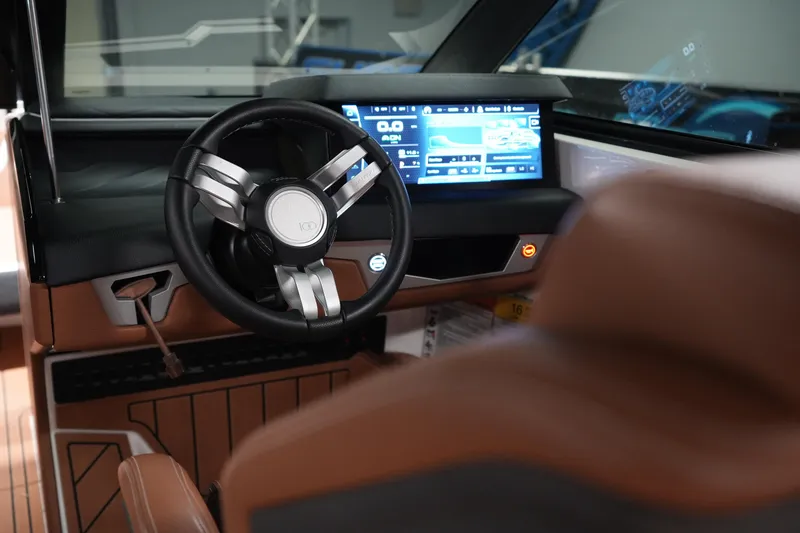 Slide: The Image of 2025 Nautique Super Air Nautique G23 dashboard with modern steering and digital display. - 19