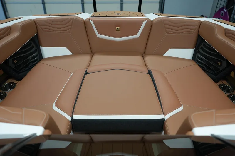 Slide: The Image of 2025 Nautique Super Air Nautique G23 interior with luxurious brown leather seating. - 17