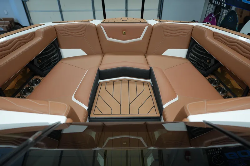 Slide: The Image of Luxurious interior of 2025 Nautique Super Air Nautique G23 boat with tan seating. - 16