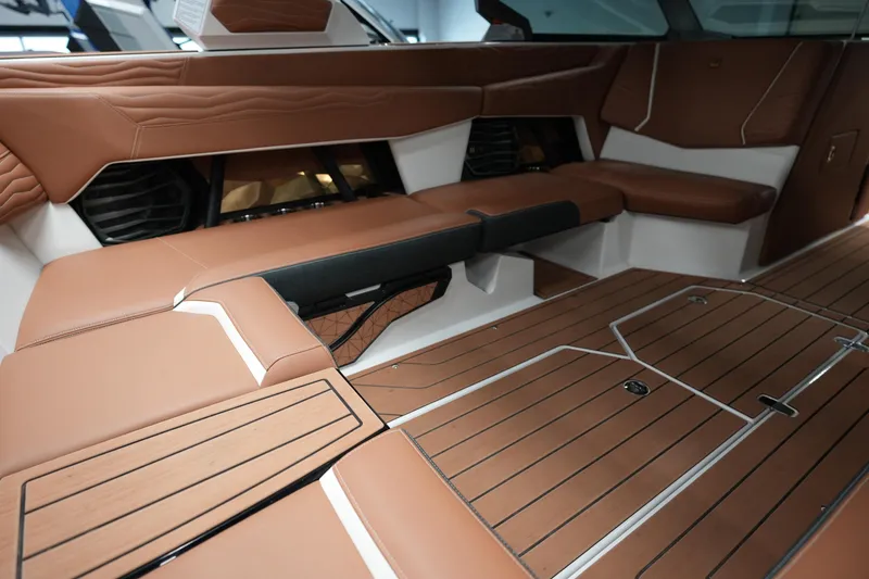 Slide: The Image of Luxurious interior of 2025 Nautique Super Air Nautique G23 with brown leather seating. - 14