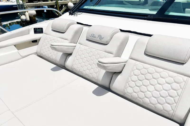 Slide: The Image of Luxurious seating on 2022 Sea Ray Sundancer 320 Coupe Outboard, featuring elegant white upholstery. - 29
