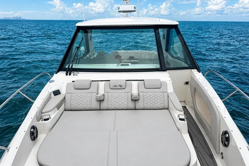 Slide: The Image of 2022 Sea Ray Sundancer 320 Coupe Outboard on open ocean, showcasing luxurious deck seating. - 30