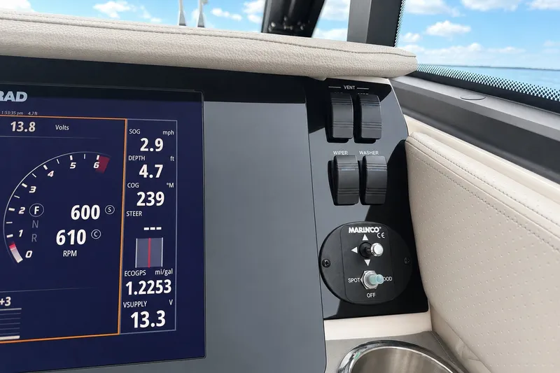 Slide: The Image of 2022 Sea Ray Sundancer 320 Coupe Outboard dashboard with digital display and control switches. - 26