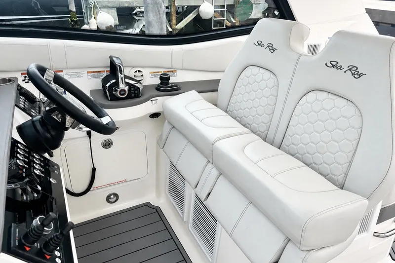 Slide: The Image of 2022 Sea Ray Sundancer 320 Coupe Outboard helm with dual seats and modern controls. - 23