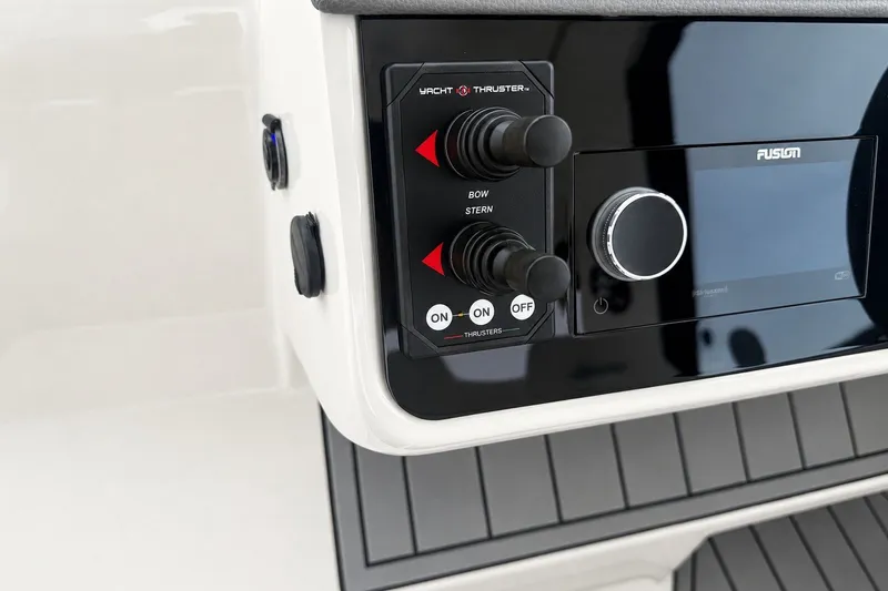 Slide: The Image of Control panel of 2022 Sea Ray Sundancer 320 Coupe Outboard with thruster controls and Fusion system. - 27