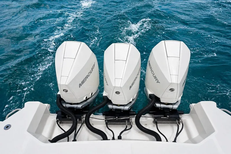Slide: The Image of Triple Mercury outboard engines on 2022 Sea Ray Sundancer 320 Coupe, cruising in blue waters. - 13