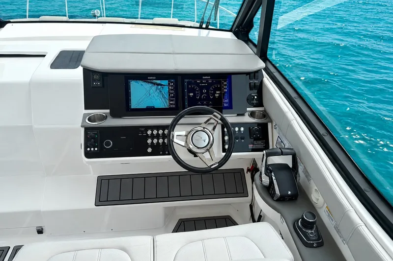 Slide: The Image of Helm of 2022 Sea Ray Sundancer 320 Coupe Outboard with navigation screens and controls. - 24