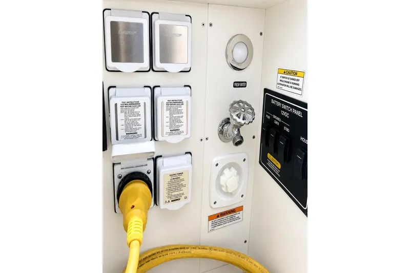 Slide: The Image of Control panel of 2022 Sea Ray Sundancer 320 Coupe Outboard with switches and power connections. - 41