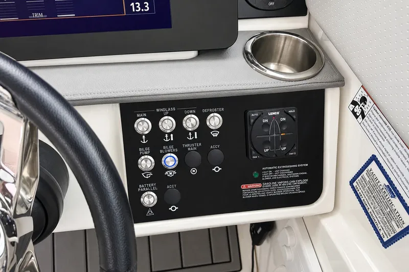 Slide: The Image of Control panel of 2022 Sea Ray Sundancer 320 Coupe Outboard with various switches and cup holder. - 25