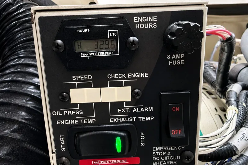 Slide: The Image of Control panel of a 2022 Sea Ray Sundancer 320 Coupe Outboard showing engine hours and switches. - 40