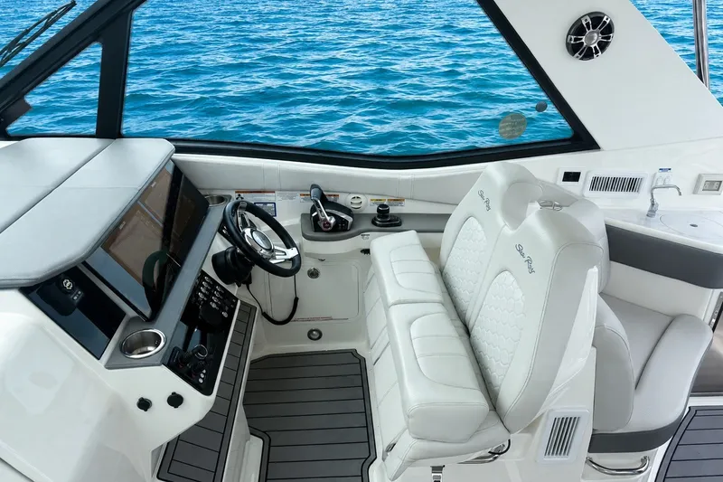 Slide: The Image of Cockpit of 2022 Sea Ray Sundancer 320 Coupe Outboard with luxurious seating and ocean view. - 22
