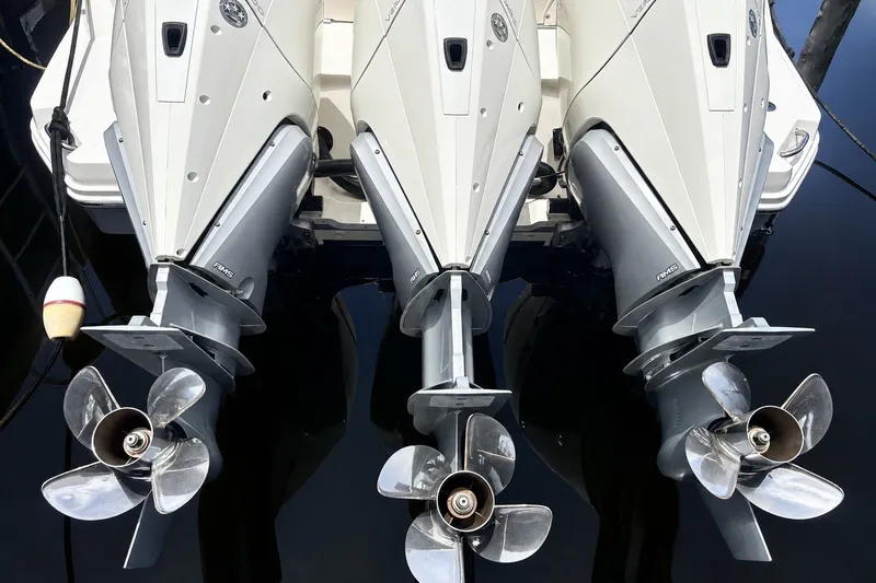 Slide: The Image of Triple outboard engines on a 2022 Sea Ray Sundancer 320 Coupe, reflecting on water. - 14
