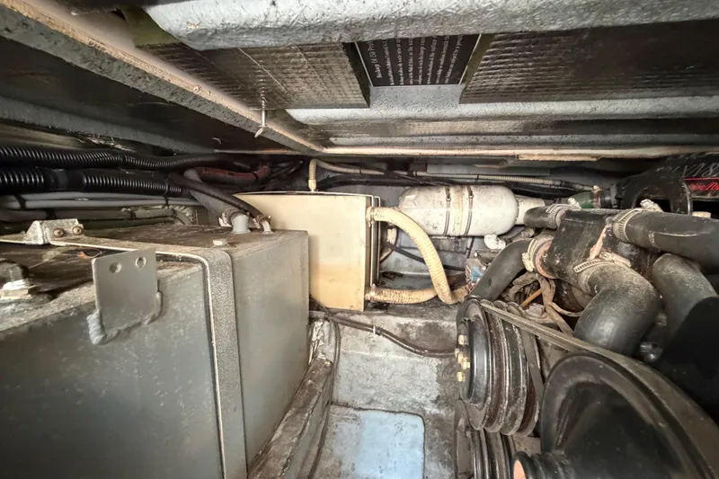 Slide: The Image of Engine compartment of a 1989 Sea Ray Sundancer 280, showing mechanical components and wiring. - 41