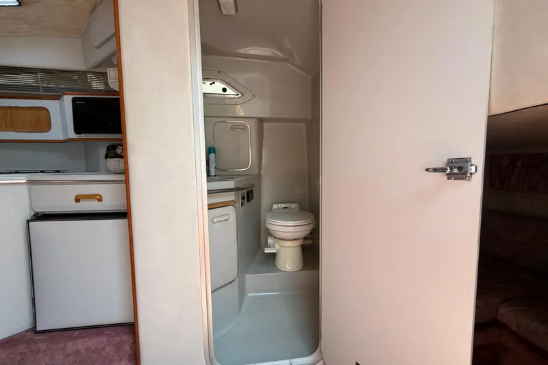 Slide: The Image of Interior of 1989 Sea Ray Sundancer 280 showing compact bathroom and kitchenette. - 35