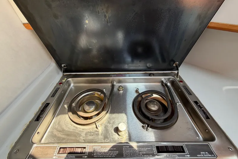 Slide: The Image of 1989 Sea Ray Sundancer 280 stove with dual burners, stainless steel finish, and alcohol fuel option. - 26