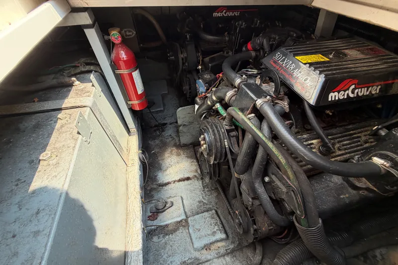 Slide: The Image of Engine compartment of a 1989 Sea Ray Sundancer 280 with MerCruiser engine and fire extinguisher. - 37