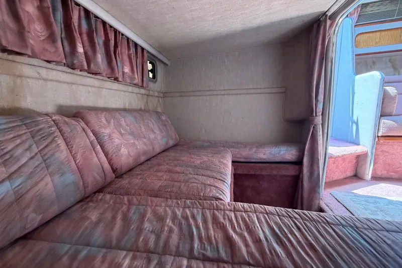 Slide: The Image of Interior cabin of 1989 Sea Ray Sundancer 280 with pink upholstery and curtains. - 33