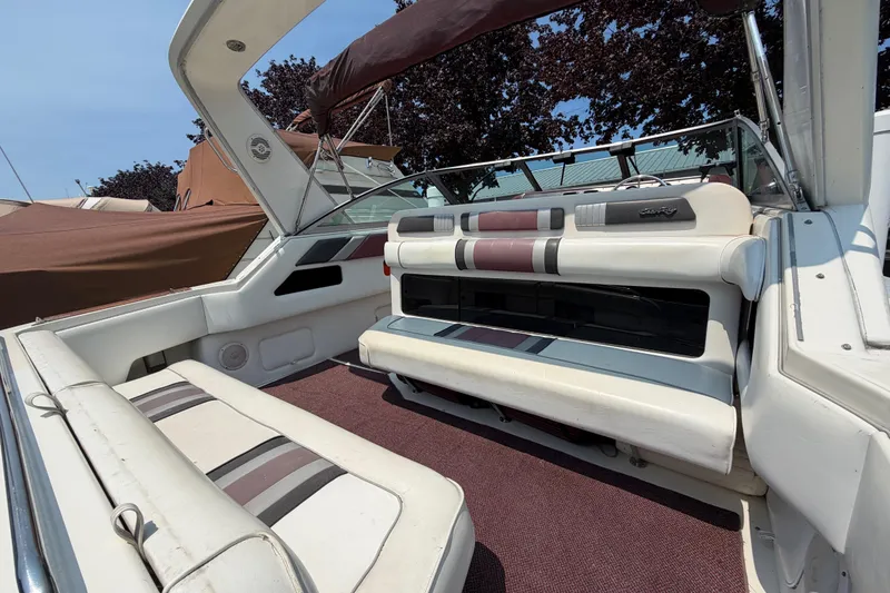 Slide: The Image of 1989 Sea Ray Sundancer 280 boat interior with white and maroon seating. - 12