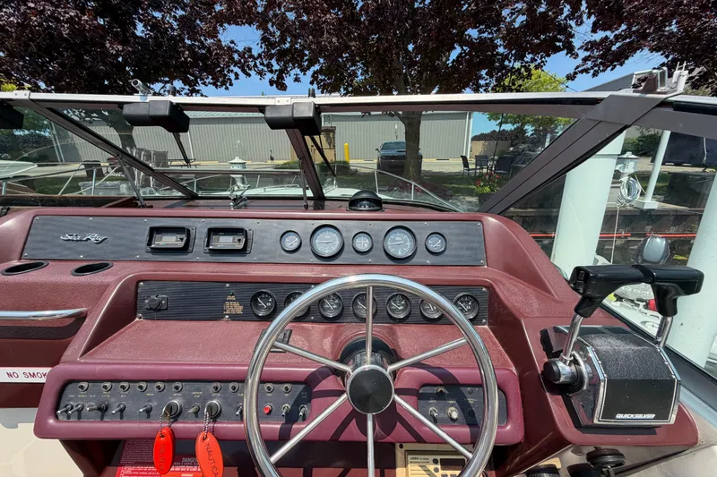Slide: The Image of Cockpit view of a 1989 Sea Ray Sundancer 280 boat with steering wheel and controls. - 17