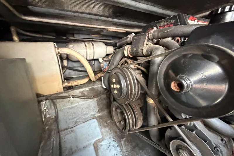Slide: The Image of Engine compartment of a 1989 Sea Ray Sundancer 280, showcasing belts and hoses. - 40