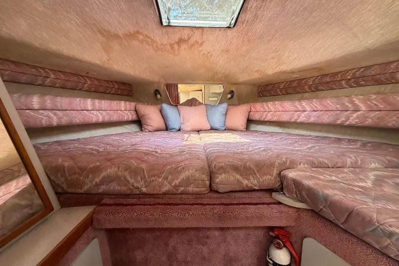 Slide: The Image of Interior cabin of 1989 Sea Ray Sundancer 280 with pink upholstery and skylight. - 27