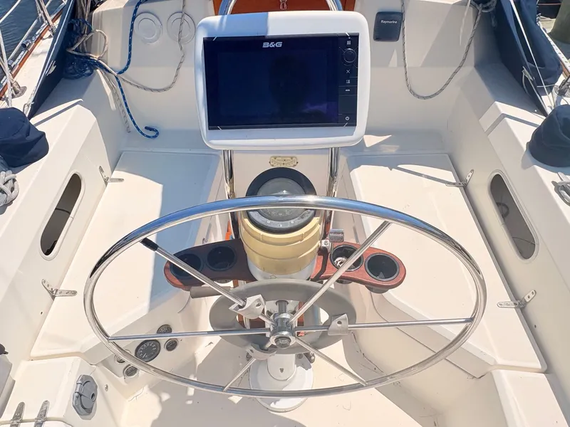 Slide: The Image of The cockpit of a 1987 Sabre 30 MK III with a large steering wheel and navigation system. - 8