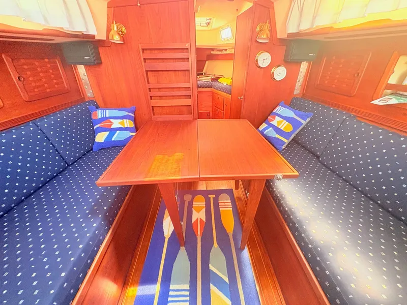 Slide: The Image of Interior of a 1987 Sabre 30 MK III with wooden table and blue upholstery. - 18