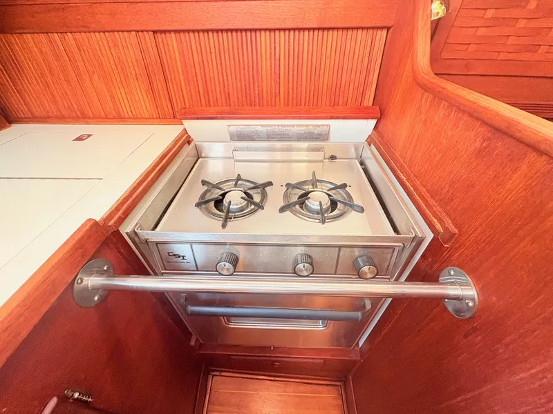 Slide: The Image of The galley of a 1987 Sabre 30 MK III with a two-burner stove and wood paneling. - 29