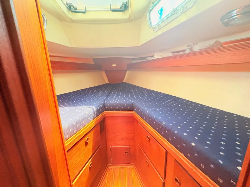 Slide: The Image of The cabin of a 1987 Sabre 30 MK III with wood paneling and blue cushions. - 21