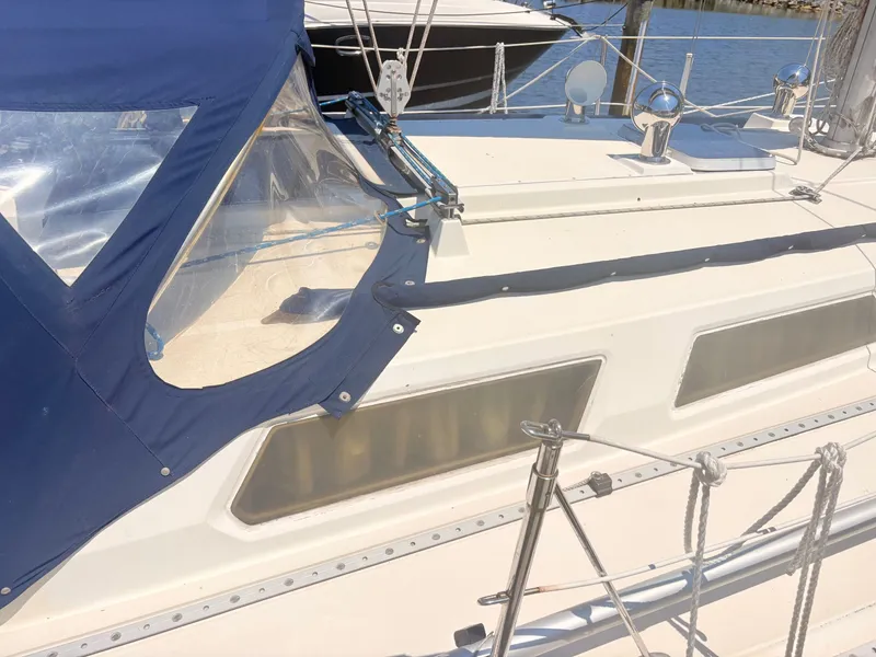 Slide: The Image of The 1987 Sabre 30 MK III features a blue canopy and clear windows on the deck. - 35