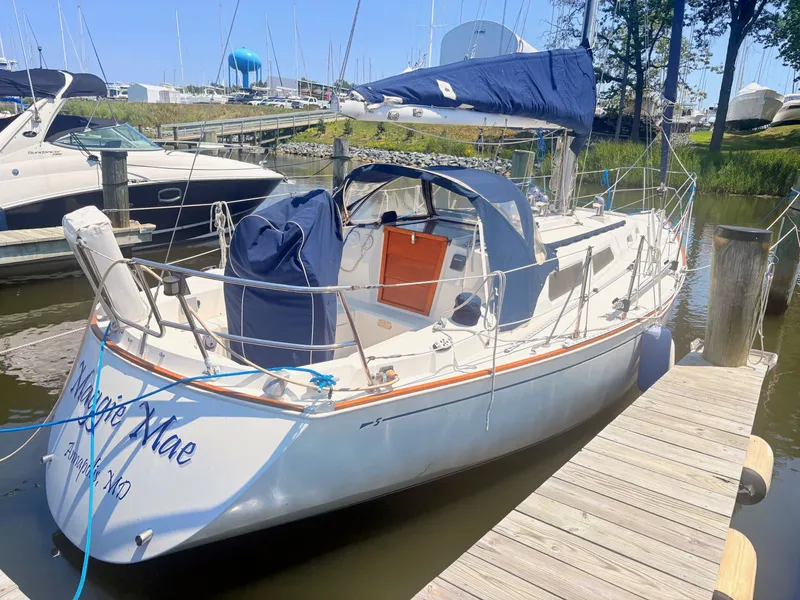 Slide: The Image of 1987 Sabre 30 MK III sailboat docked with blue covers and sails. - 2