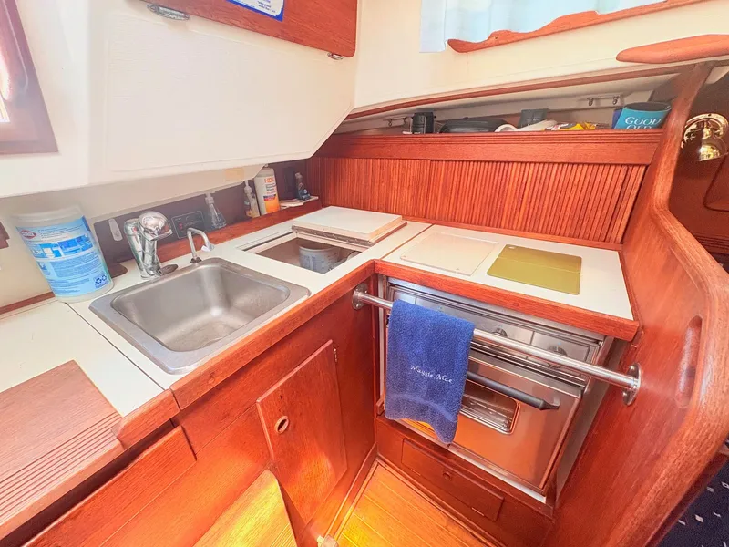 Slide: The Image of The galley of a 1987 Sabre 30 MK III with a sink, stove, and wood paneling. - 14