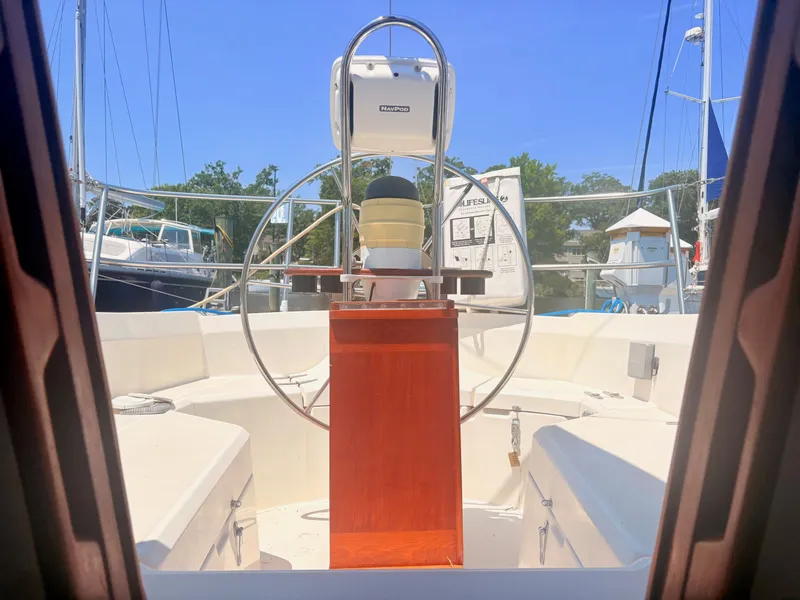 Slide: The Image of View from inside a Sabre 30 MK III sailboat towards the cockpit with a steering wheel and instruments. - 32