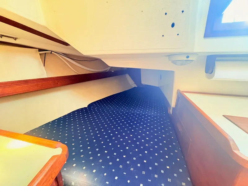 Slide: The Image of The cabin of a 1987 Sabre 30 MK III with blue upholstery and wood accents. - 28