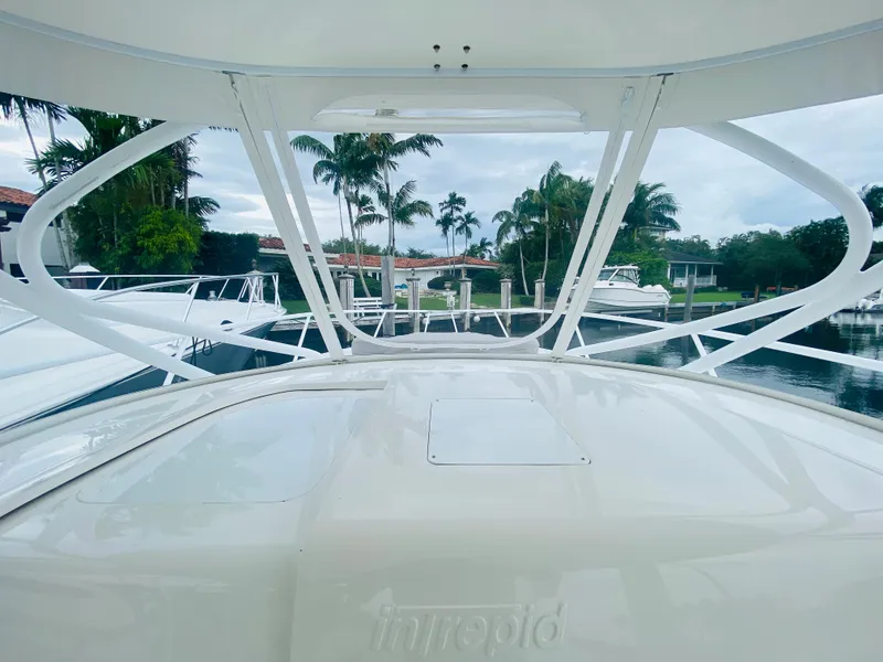 Slide: The Image of 2008 Intrepid 390 Sport Yacht docked, view from the bow with palm trees in the background. - 33