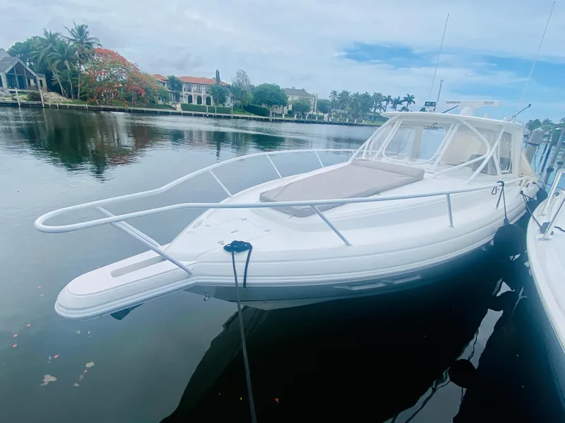 Slide: The Image of 2008 Intrepid 390 Sport Yacht docked by waterfront homes. - 5
