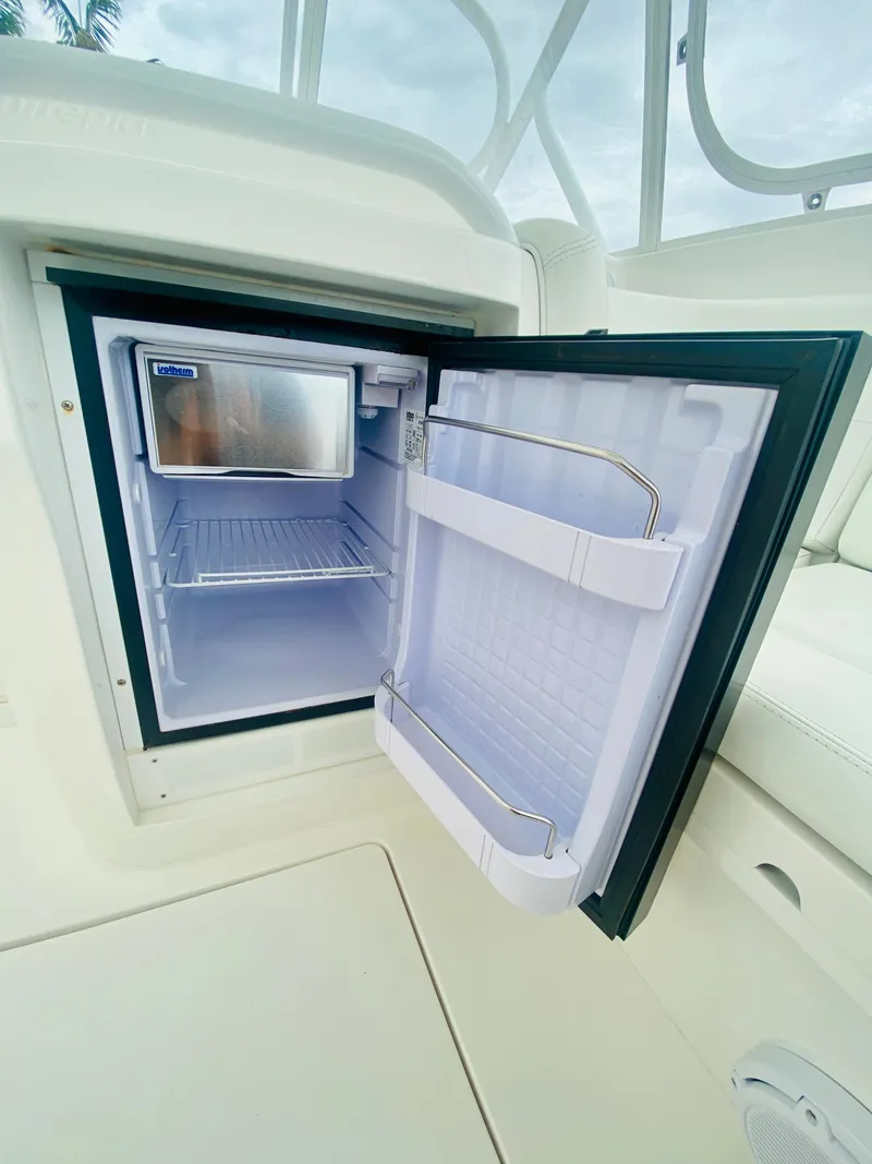 Slide: The Image of Open refrigerator on 2008 Intrepid 390 Sport Yacht, showcasing interior storage. - 43