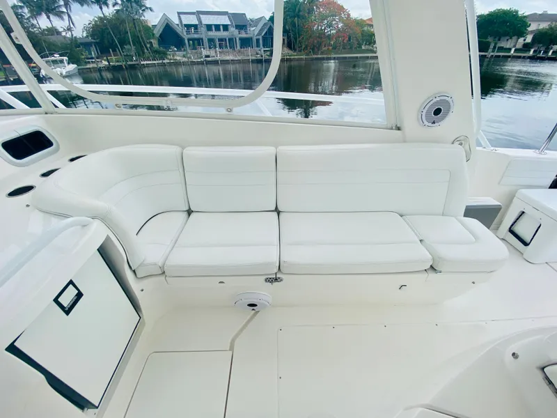 Slide: The Image of 2008 Intrepid 390 Sport Yacht white cushioned seating area. - 32