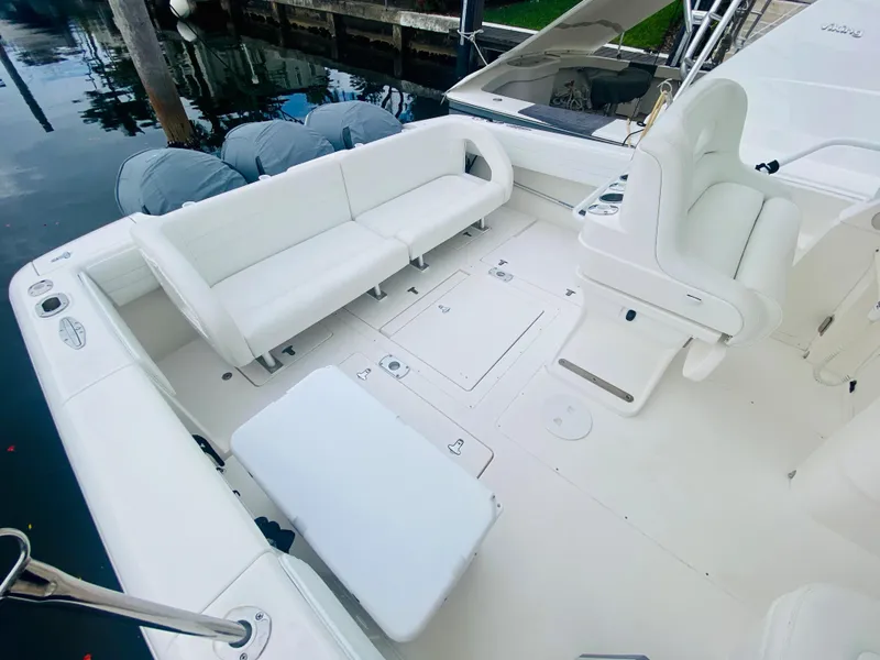 Slide: The Image of 2008 Intrepid 390 Sport Yacht with white seating and spacious deck. - 25