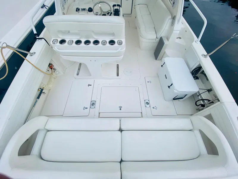 Slide: The Image of 2008 Intrepid 390 Sport Yacht interior with white seating and fishing rod holders. - 22
