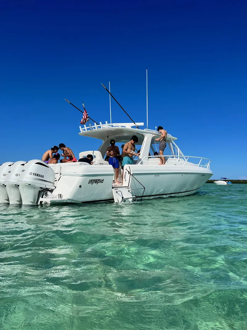 Slide: The Image of 2008 Intrepid 390 Sport Yacht in clear blue waters with people onboard. - 3
