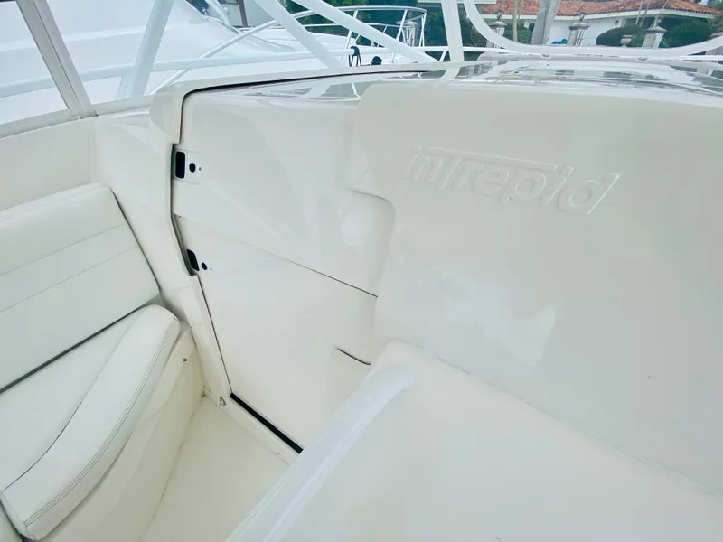 Slide: The Image of 2008 Intrepid 390 Sport Yacht interior with white seating and embossed logo. - 50